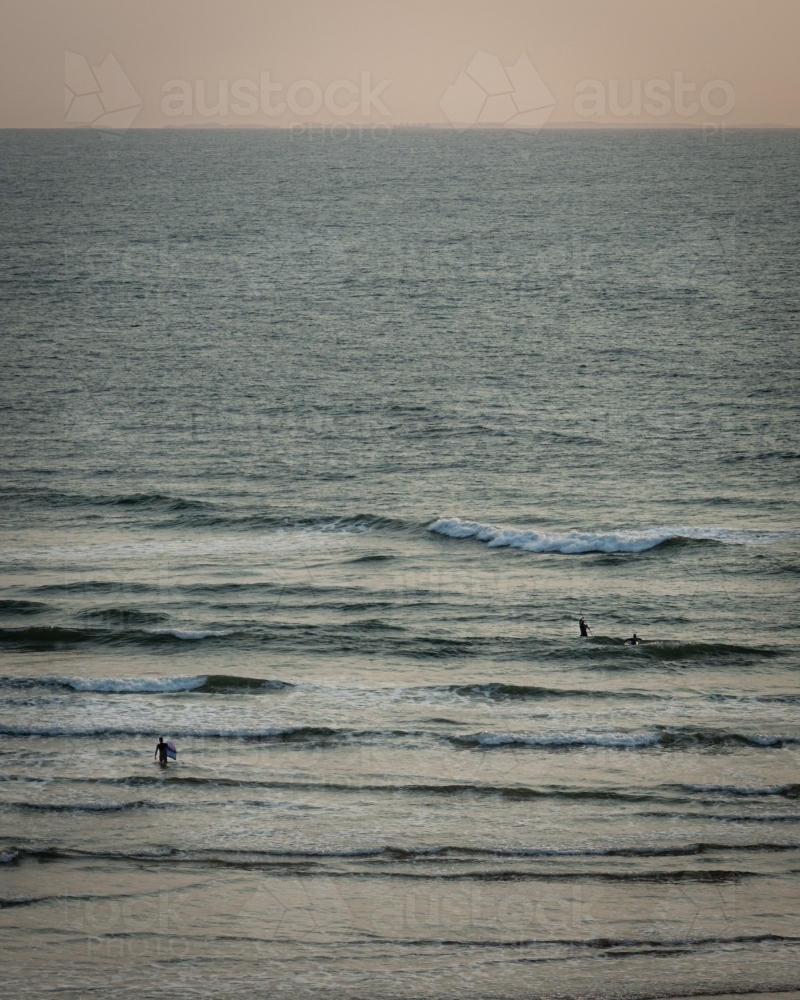 Surfers Paddling into Great Ocean Road Morning Waves - Australian Stock Image