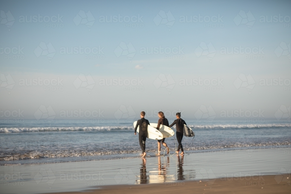 Surfers running towards water - Australian Stock Image