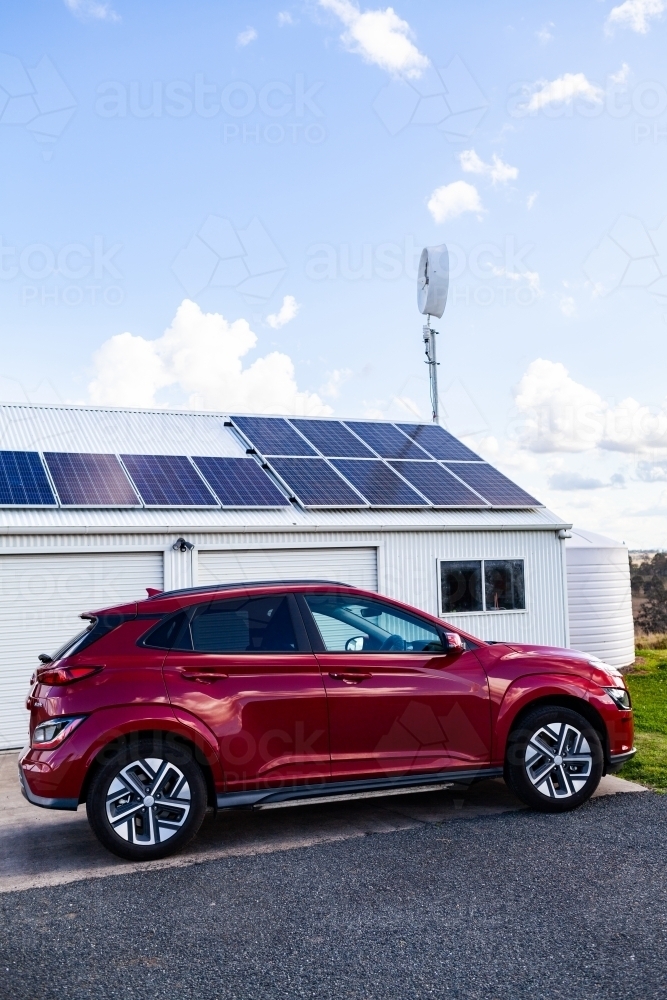 sustainable off grid living with electric vehicle car and solar power and wind turbine - Australian Stock Image