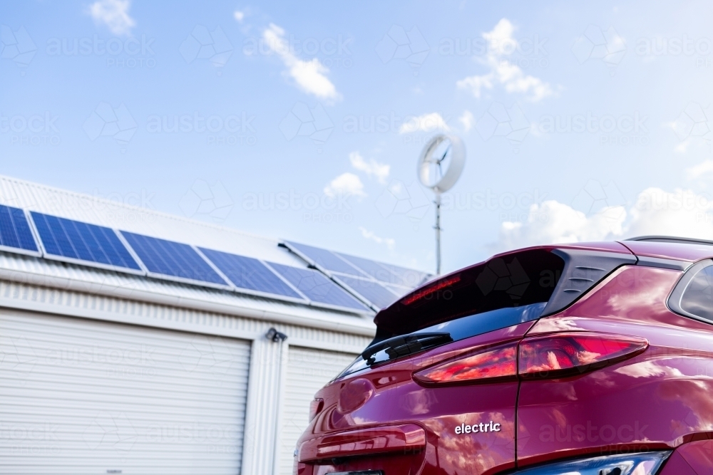 sustainable off grid living with electric vehicle car and solar power and wind turbine - Australian Stock Image