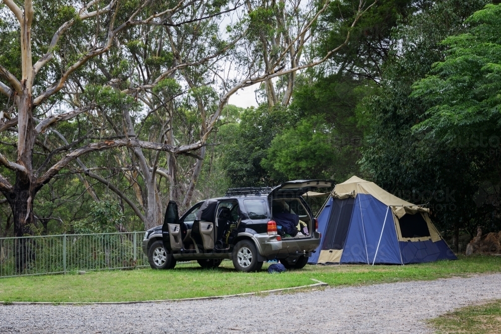 SUV and tent set up on campsite overlooking beautiful bushland - Australian Stock Image