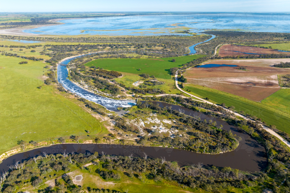 Sweeping aerial view of winding rivers, wetlands, and patchwork farmland - Australian Stock Image