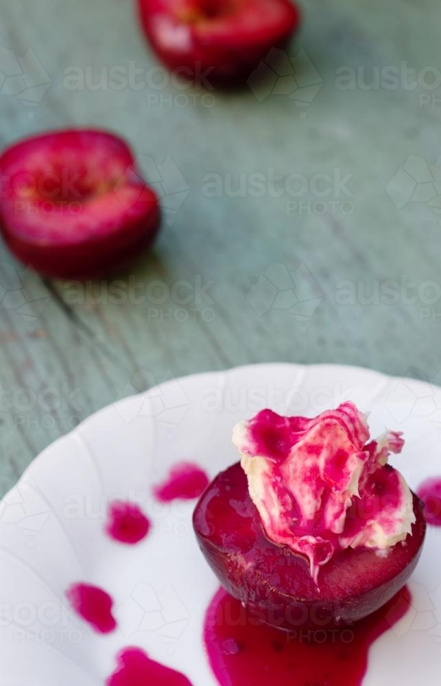 sweet plum with whipped cream and a warm cinnamon plum sauce - Australian Stock Image