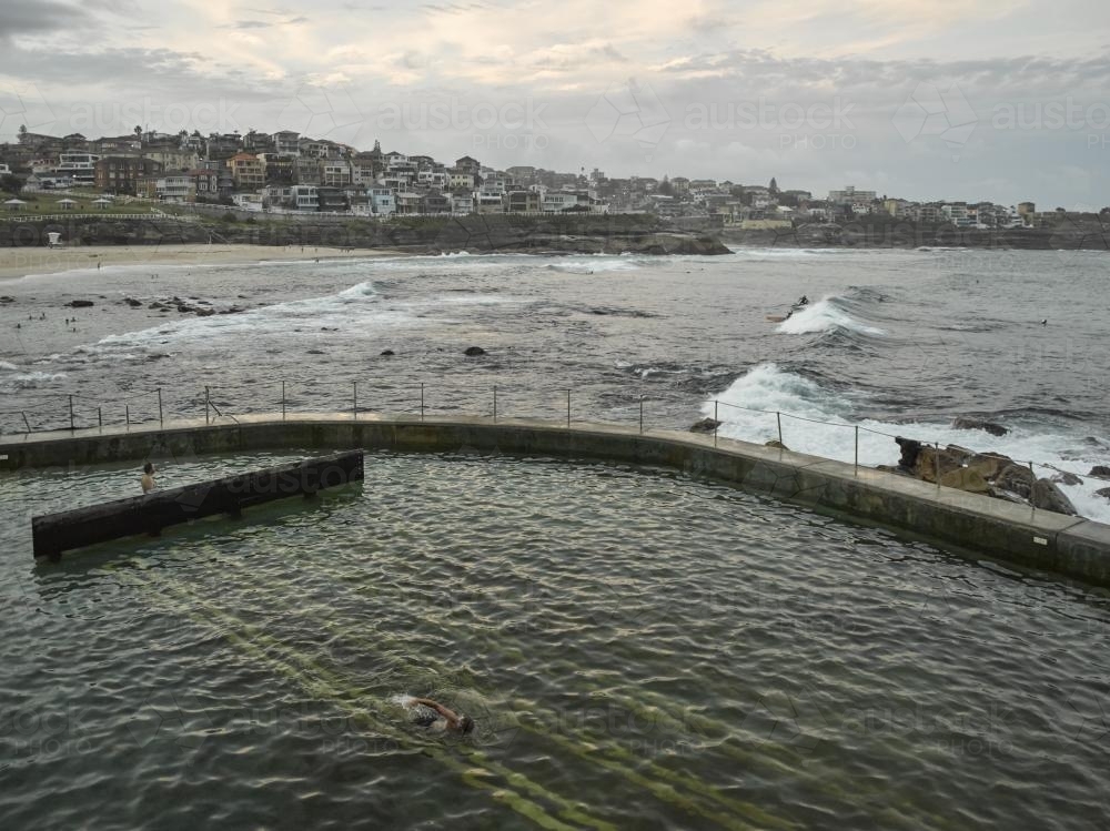 Swimmers at Bronte Ocean Pool on an overcast day - Australian Stock Image