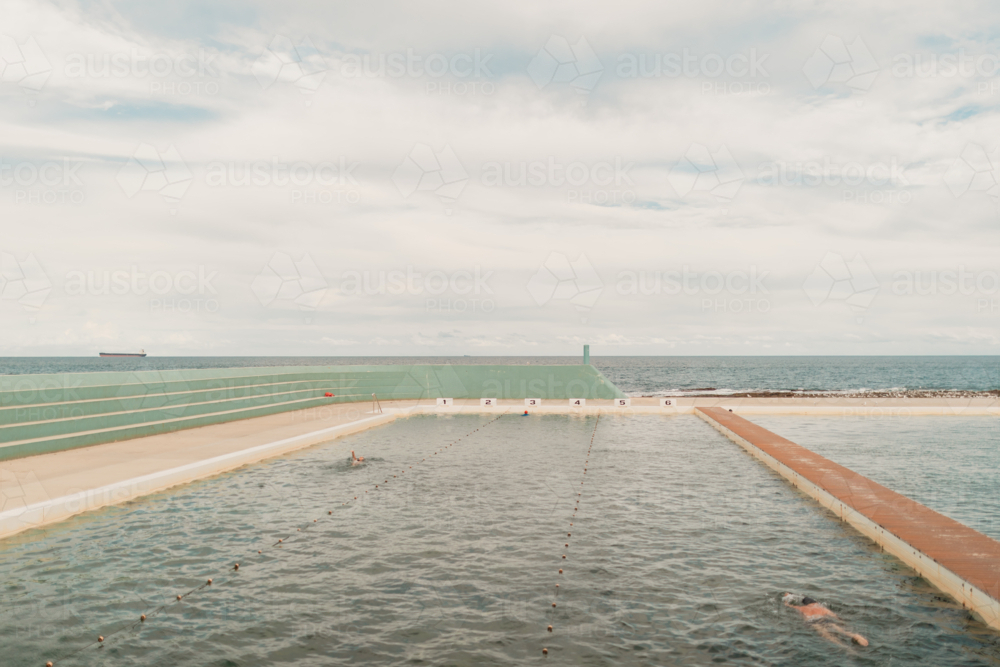 Swimming lanes at the Newcastle Ocean Baths in New South Wales, with ocean views in the background - Australian Stock Image