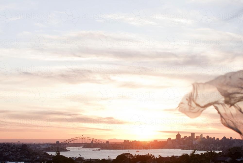 Sydney at sunset with harbour bridge and city skyline - Australian Stock Image