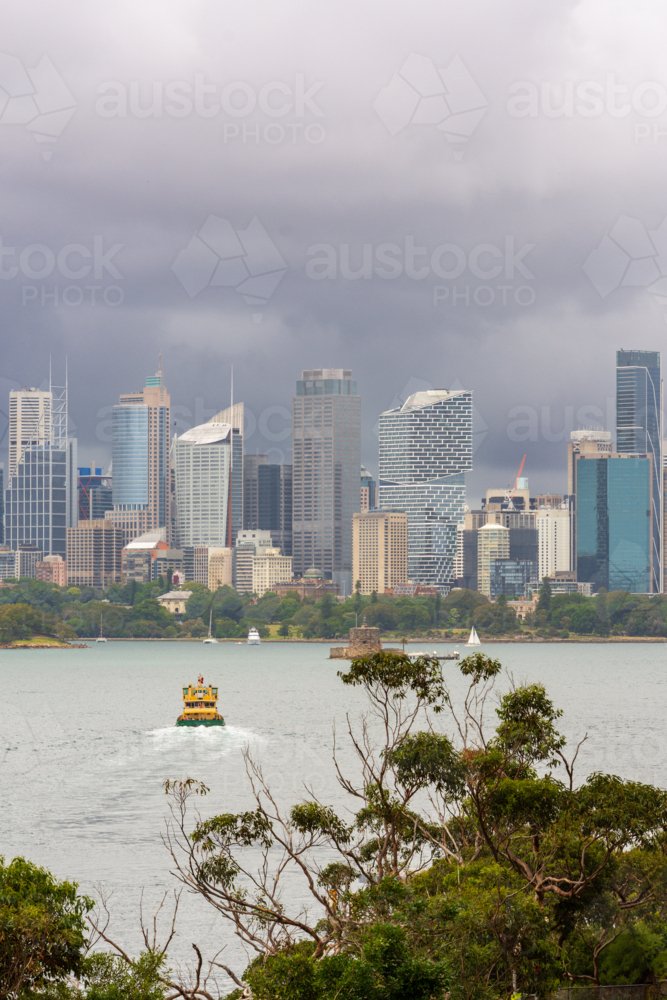 Sydney CBD with Storm Clouds as seen from Mosman with ferry in harbour - Australian Stock Image