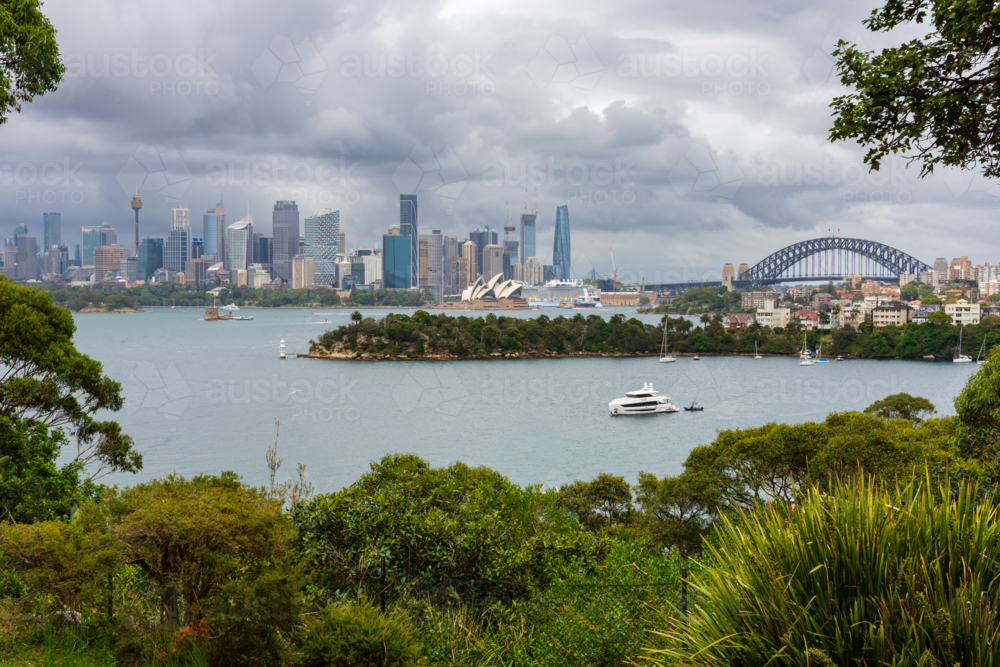 Sydney City, Opera House and Harbour Bridge on a cloudy day as seen from Mosman - Australian Stock Image