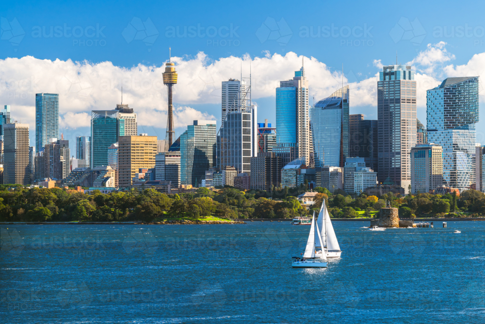 Sydney city skyline panorama with tower and modern skyscrapers viewed across the harbour - Australian Stock Image