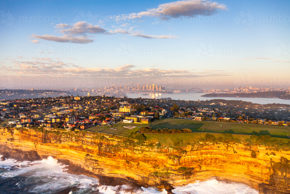 Sydney cliffs with Harbour Bridge and skyline at sunset - Australian Stock Image