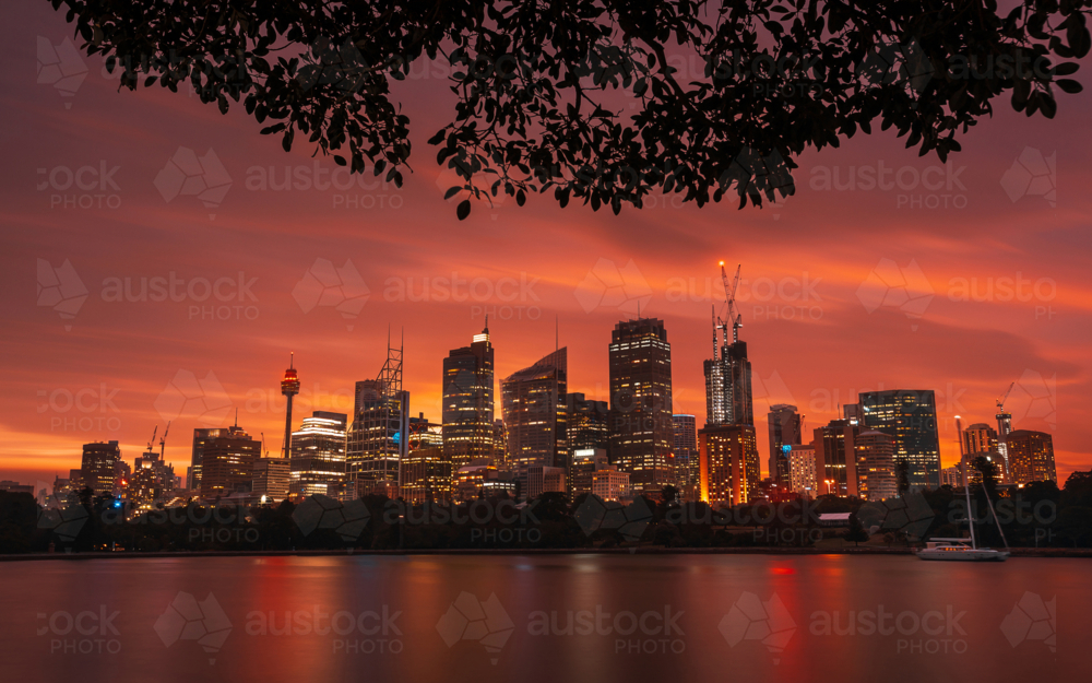 Sydney skyline at sunset across water - Australian Stock Image