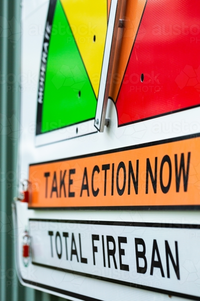 Image of take action now total fire ban signage on fire station wall ...