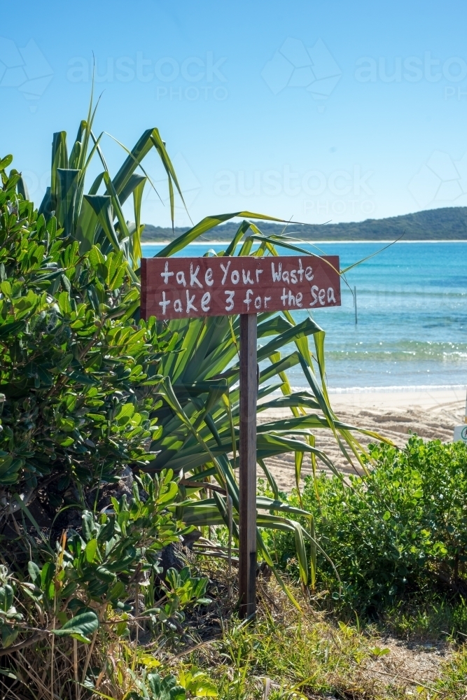 Take your Rubbish sign on coastline with beach in background - Australian Stock Image