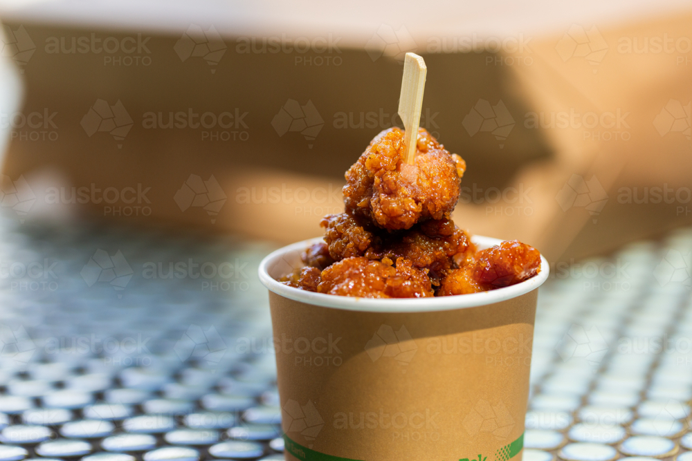 Image of takeaway teriyaki chicken in paper cup with wooden skewer ...