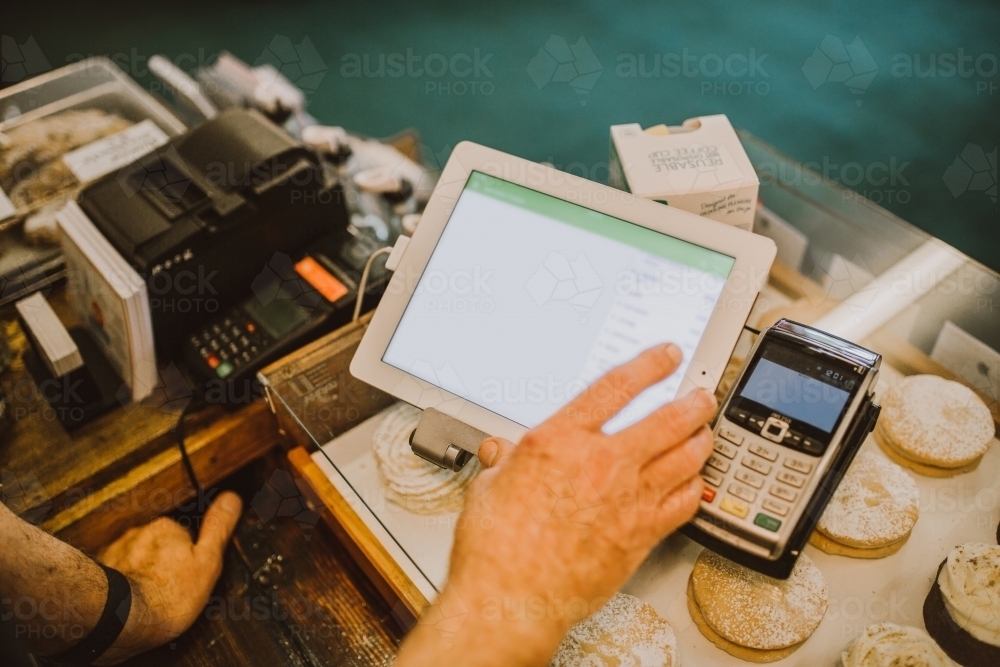 Taking payment at cafe counter - Australian Stock Image