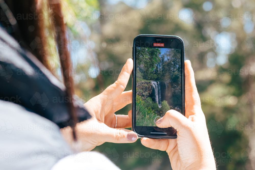 Taking photo of waterfall - Australian Stock Image