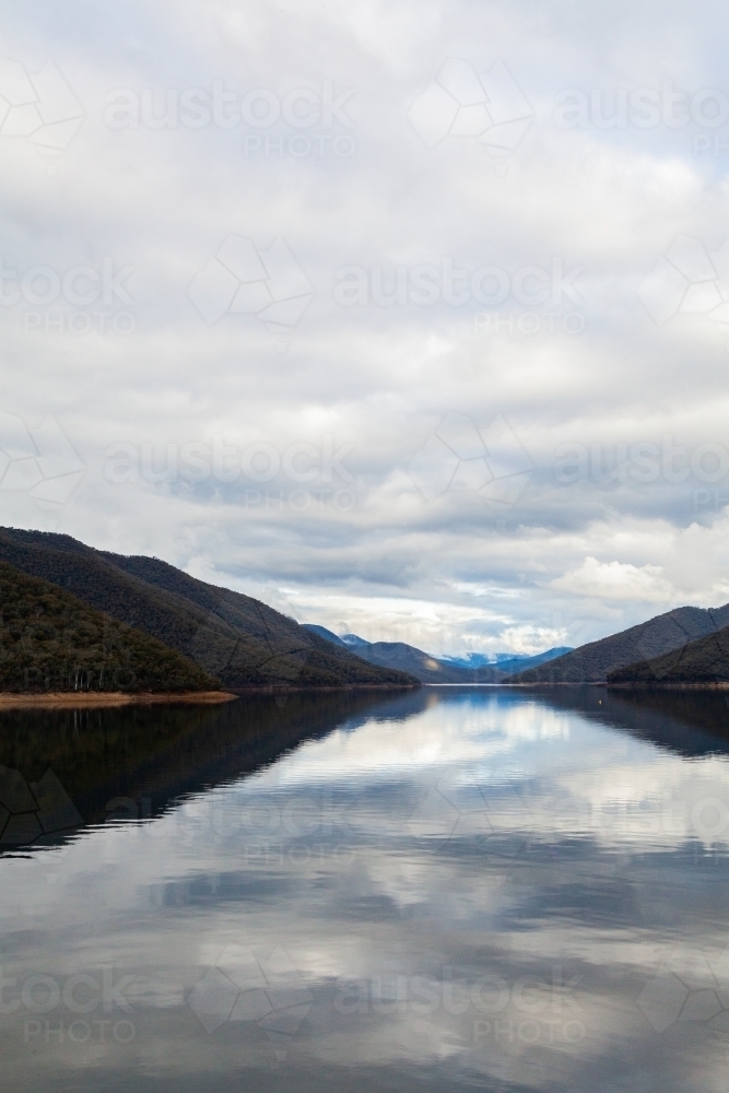 Talbingo Dam scenery with still water on overcast day in early winter - Australian Stock Image
