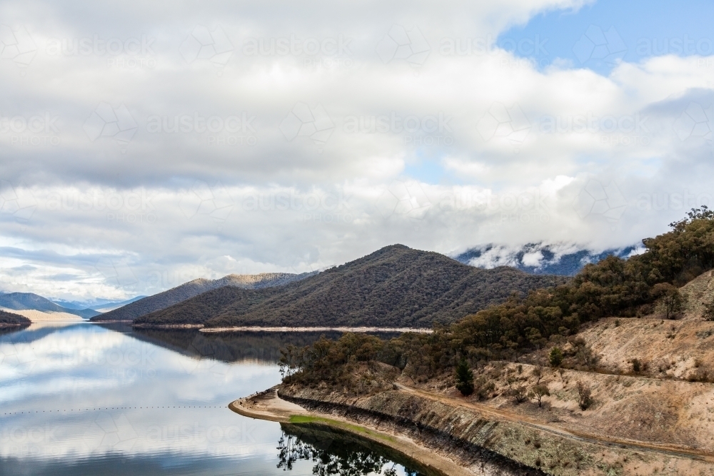Talbingo Dam scenery with still water on overcast day in early winter - Australian Stock Image