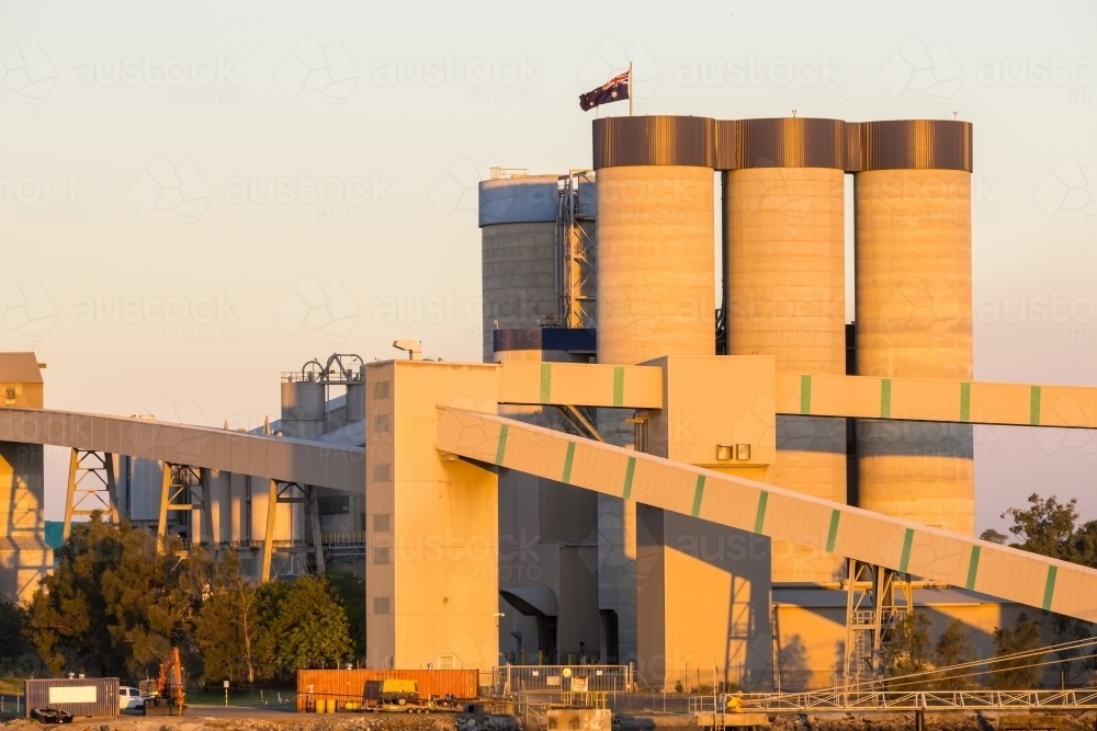 Tall grain silos and conveyor chutes at the Port of Brisbane - Australian Stock Image