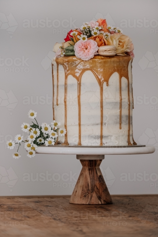 Tall layer cake with fresh flowers - Australian Stock Image