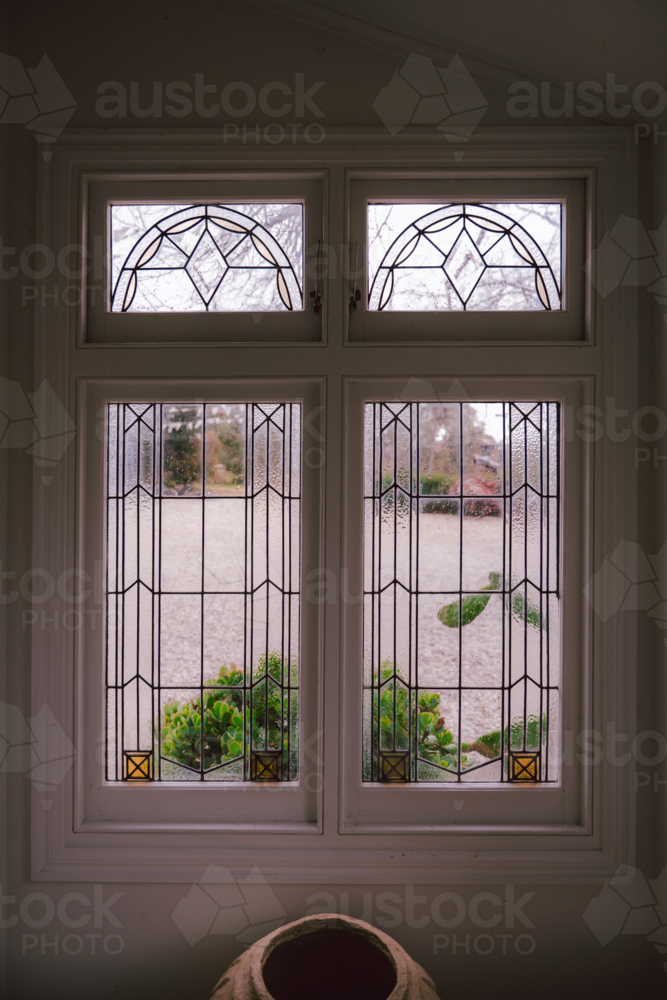 Tall narrow geometric stained-glass window - Australian Stock Image