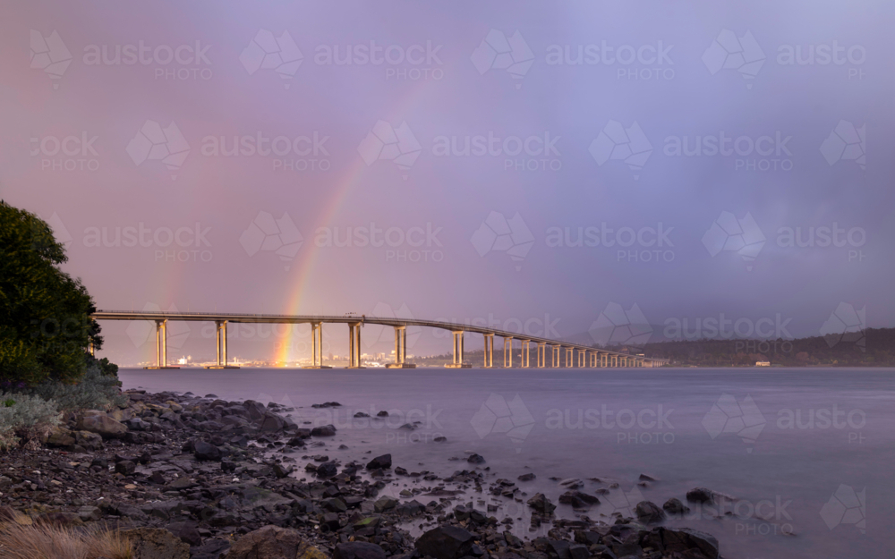 Tasman bridge at sunrise with rainbow behind - Australian Stock Image