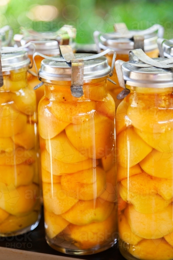 Tasty fresh homemade preserved apricot fruit in glass jar - Australian Stock Image
