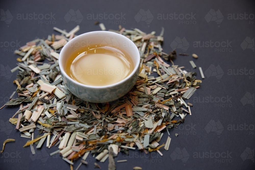 Tea leaves and drink on table - Australian Stock Image