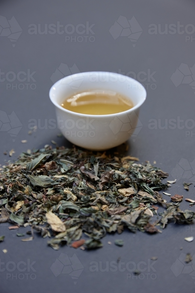 Tea leaves and drink on table - Australian Stock Image