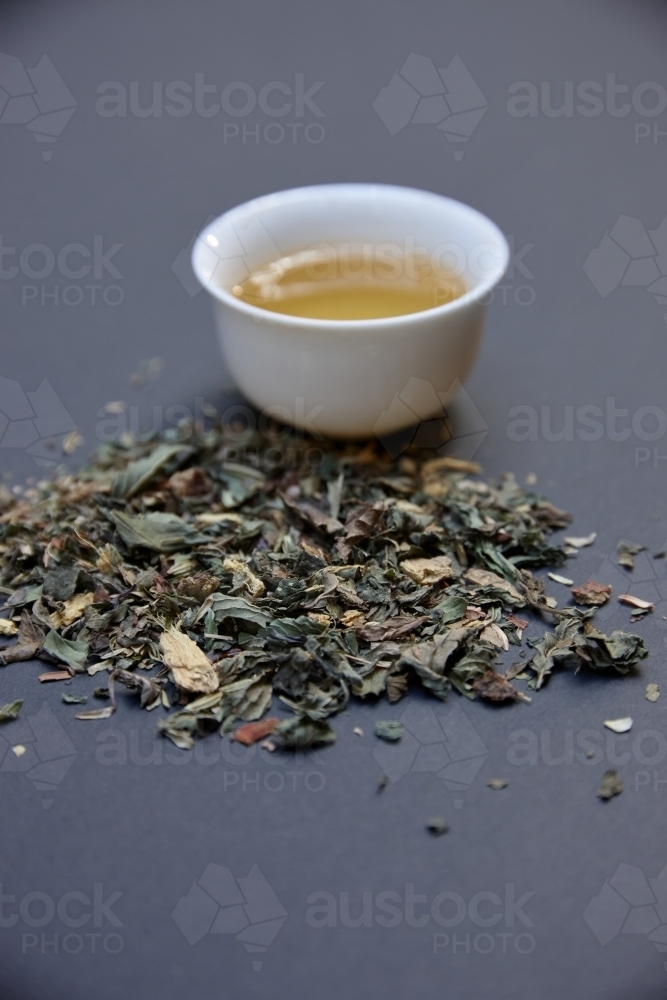 Tea leaves and drink on table - Australian Stock Image