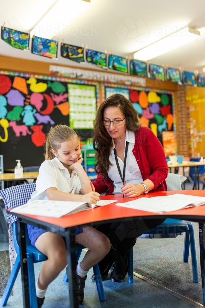 Teacher and Student Working Together in Classroom - Australian Stock Image