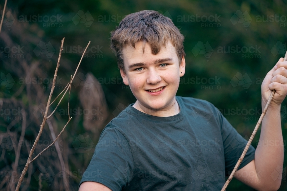 Teen boy in nature with happy smile - Australian Stock Image