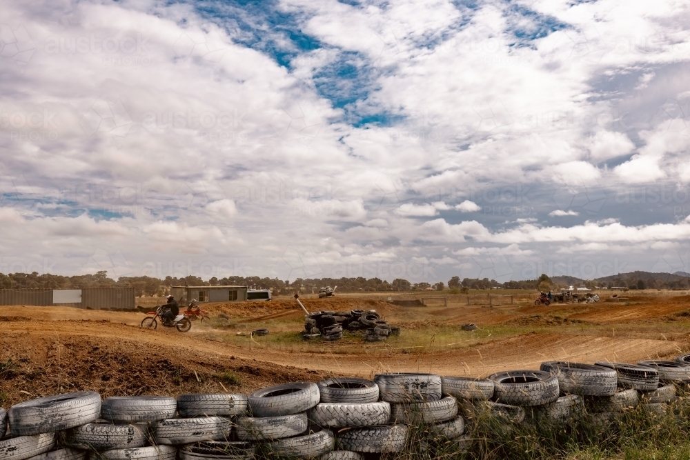 Teen boy riding motorbike at motocross track meet - Australian Stock Image