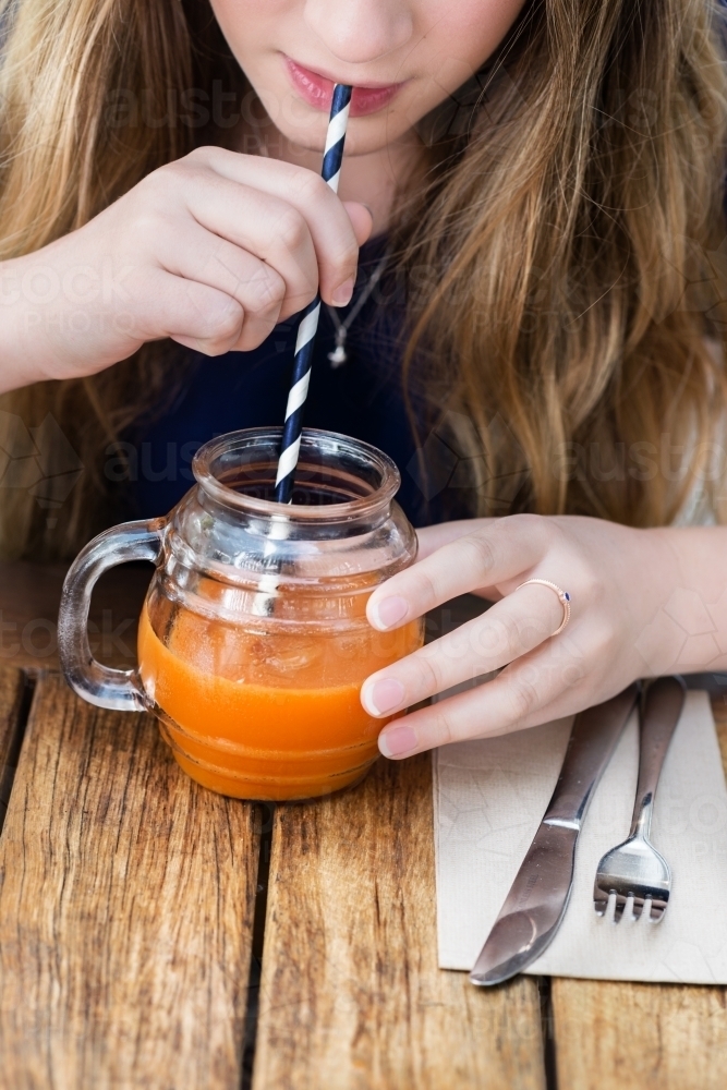 Image of teen enjoying a juice drink at a c