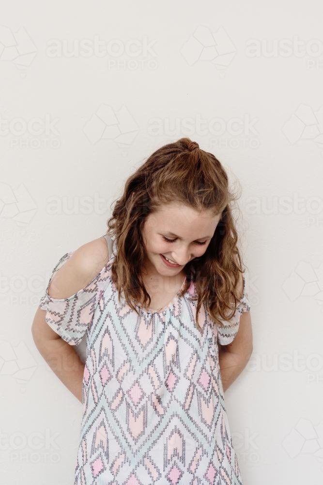 Teen girl against a blank wall - Australian Stock Image
