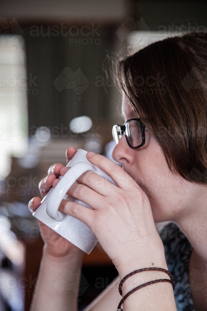 Teen girl drinking coffee - Australian Stock Image