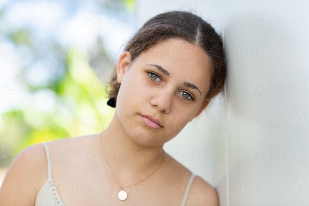 Image of Teen girl head and shoulders looking at camera - Austockphoto