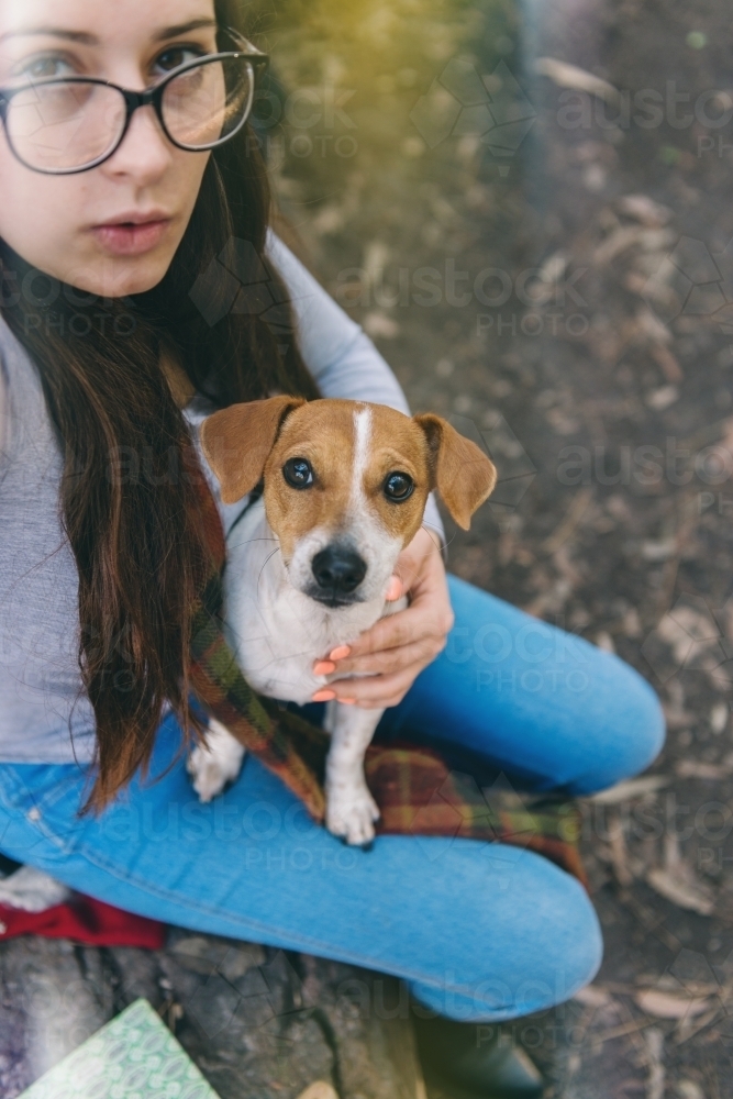 teen girl in forest with her dog - Australian Stock Image