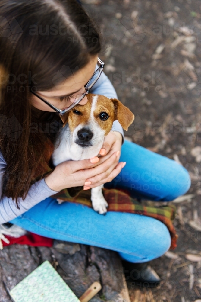 teen girl in forest with her dog - Australian Stock Image