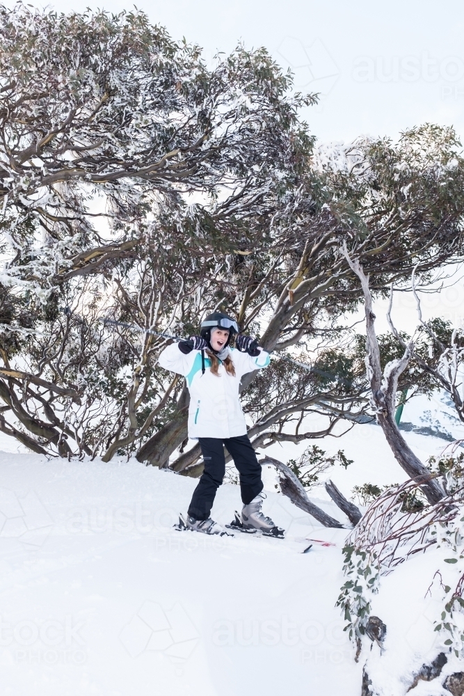 teen girl making a fun pose on the ski slopes - Australian Stock Image