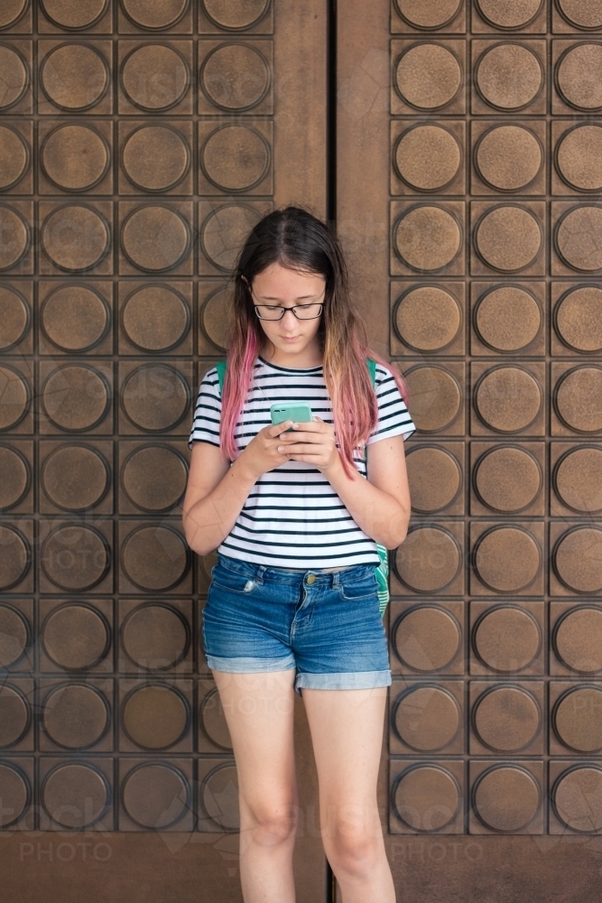 teen girl texting on phone - Australian Stock Image