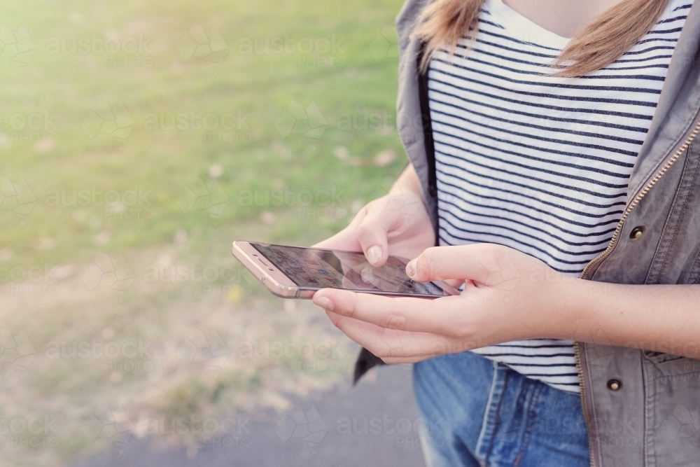 Teen girl using mobile phone - Australian Stock Image