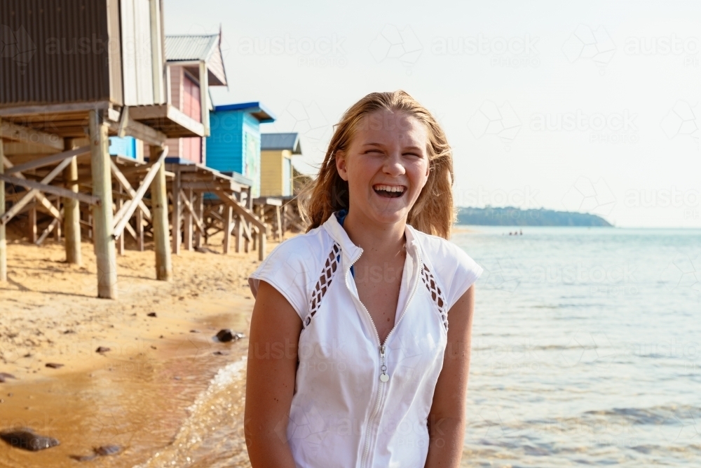 teen girl wearing rashie at the beach - Australian Stock Image