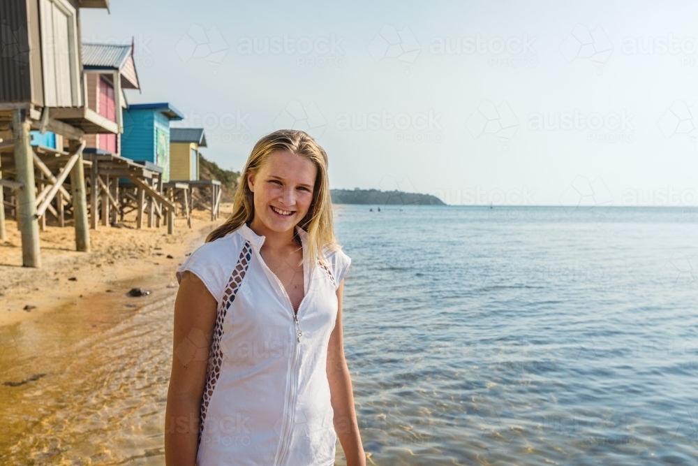 teen girl wearing rashie at the beach - Australian Stock Image