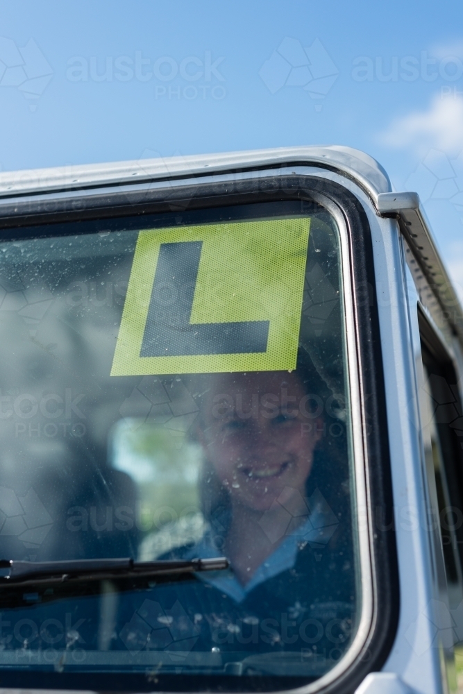 teen girl with a L sticker on windscreen - Australian Stock Image