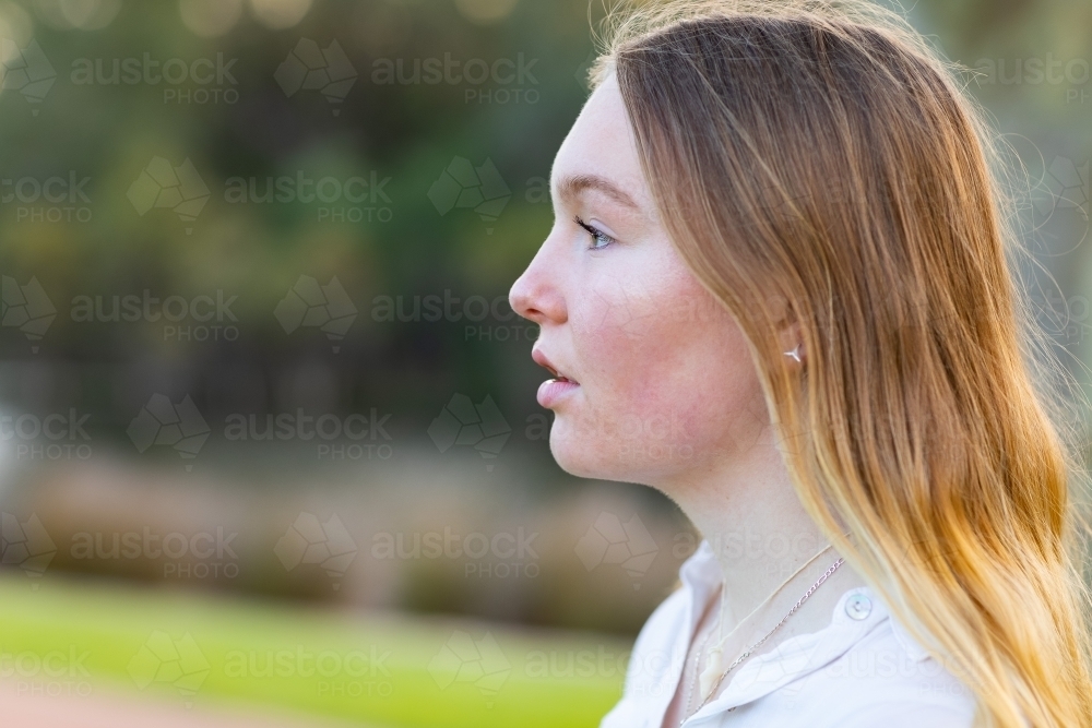 Teen girl with long blonde hair in profile - Australian Stock Image