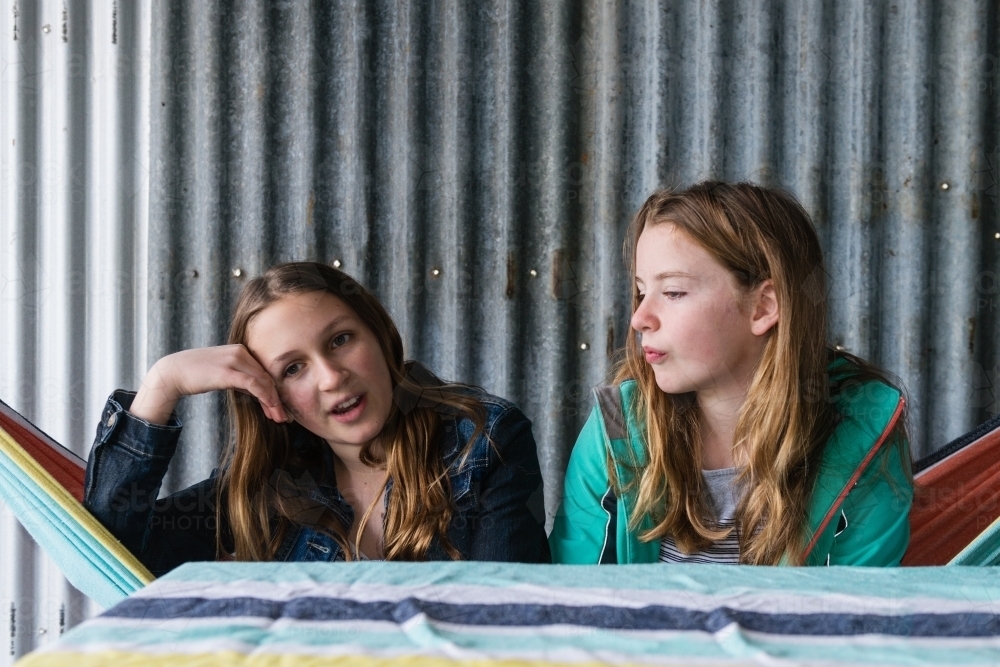 teen girls hanging out in a cubby house - Australian Stock Image