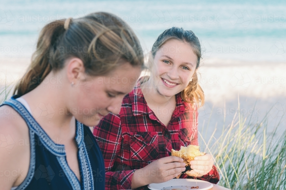 teen girls on a camping trip by the beach, eating jaffles - Australian Stock Image