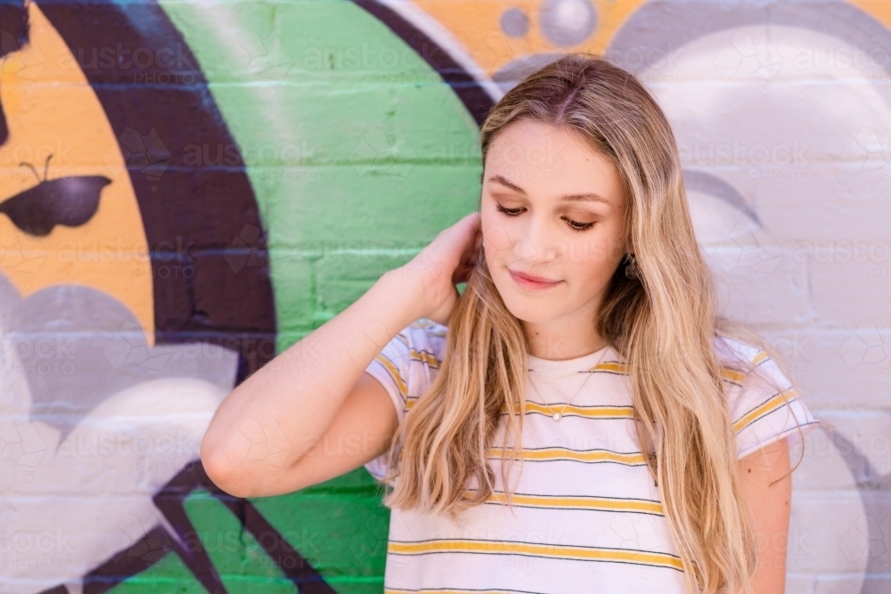 teen leaning against wall - Australian Stock Image