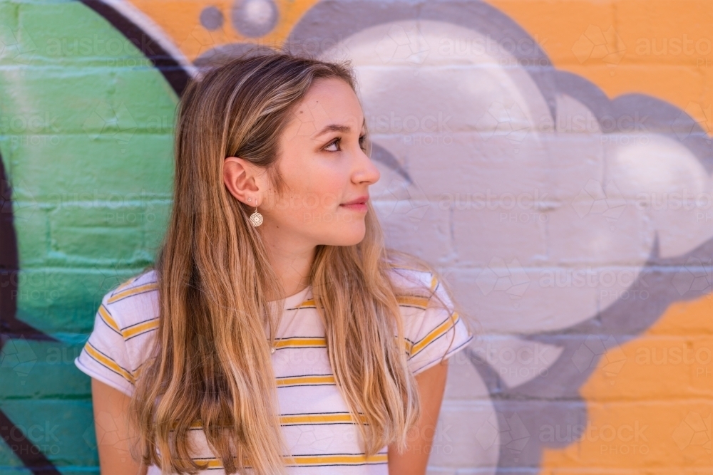 teen leaning against wall - Australian Stock Image